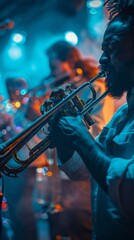 Close-up image of male musician on stage playing trombone with blurred band on background in night...