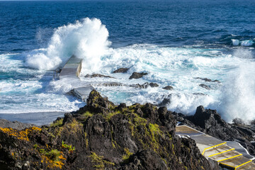 Powerful waves crash along the shoreline of Cinco Ribeiras, a scenic bathing area on Terceira...