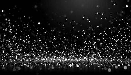 White bokeh particles on a black background