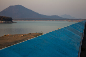 Fototapeta na wymiar The parapet wall of the view point along the Sathanur Dam which forms the Sathanur reservoir. Focus set of foreground