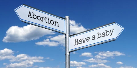 Fototapeta premium Have a baby or abortion - metal signpost with two arrows