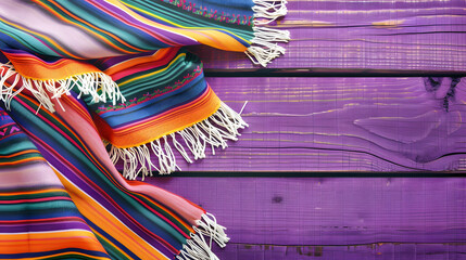 Colorful Mexican serape in the style of background on a wood table, copy space for text. Cinco de mayo. The day of the dead. Dia de los Muertos