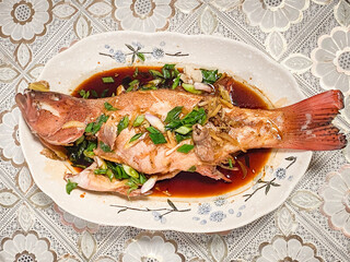 Delicious Steamed Fish with Aromatic Herbs and Savory Sauce