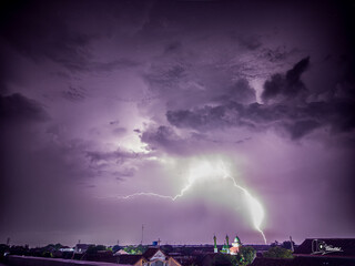 A purple sky with a lightning bolt in the middle
