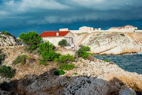 abandonned house with a red roof in a stormy sea landscape