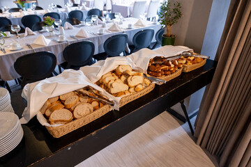 Breakfast Buffet Display Featuring Baskets of Freshly Sliced Bread, Ready for Guests at a Hotel or...