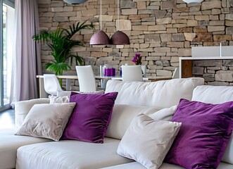 Modern living room interior with a white sofa, stone wall and purple pillows