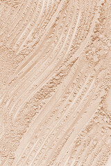 Chic abstract background of loose powder in natural tone. Vertical view. A copy of the space. Cosmetic background. Layout for design.