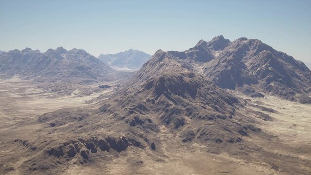 A breathtaking aerial view of majestic mountains in the vast desert landscape