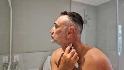 Man Shaving His Face in the Mirror