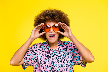 Photo of cheerful impressed lady dressed leopard print shirt arms sunglass open mouth isolated...