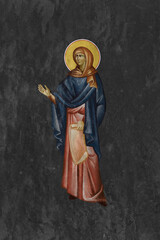 Christian traditional image of Anna the Prophetess. Religious illustration on black stone wall background in Byzantine style