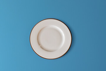 Ceramic white flat plate for food on the table