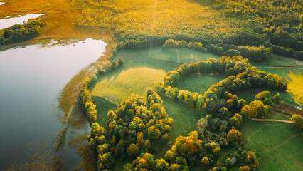 Aerial View Of Green Forest And Meadow Hill Landscape Near River. Top View Of Beautiful Nature From...