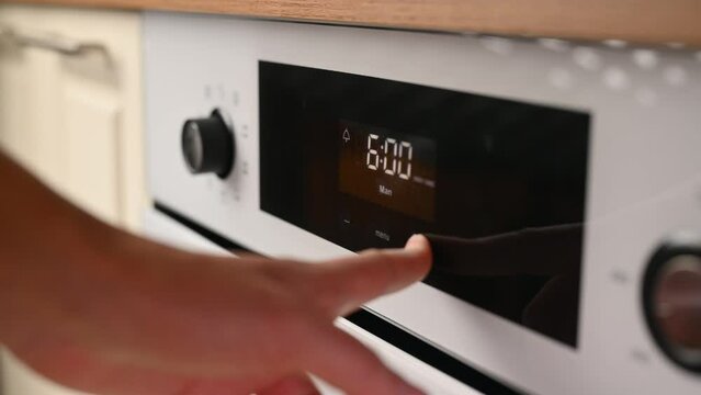 Close-up of setting the timer on the oven screen