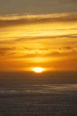 Orange sky with clouds on the ocean at sunset in Madeira island, Portugal - 777387950