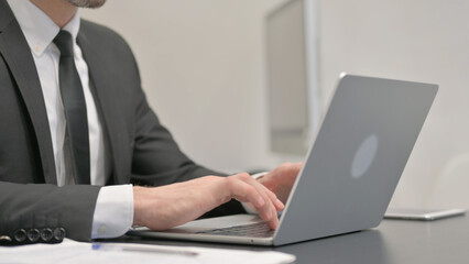Close up of Businessman Typing on Laptop