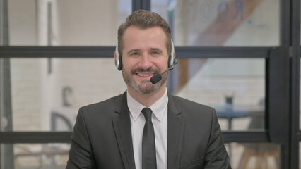 Portrait of Smiling Call Center Employee with Headset