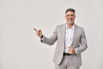 Happy middle aged business man entrepreneur, smiling older professional manager, confident businessman looking at camera pointing aside advertising business offer isolated on white background. - 777396138
