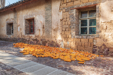 Corn cobs are drying on the street in the historic town of Tuanshan, Yunnan province China