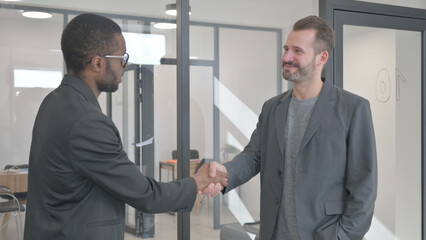 Business People Shaking Hand During Meeting in Office