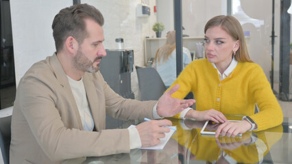 Team of Young Entrepreneurs Talking in Office