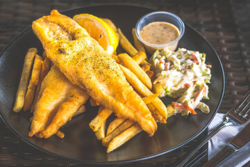 white fish fish and chips served with french fries and coleslaw and tartar sauce