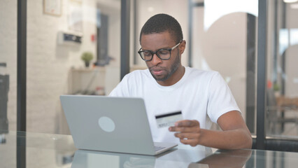 African American Man Shopping Online on Laptop
