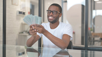 African American Man Enjoying Moment while Holding Money