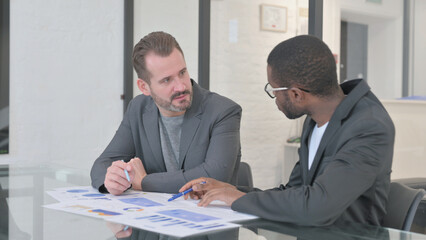 Mixed Race Teammates Working on Business Report