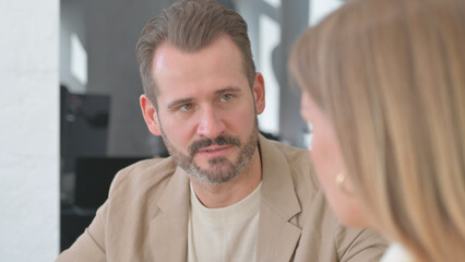 Fototapeta premium Close Up of Man Talking in Meeting Female Worker