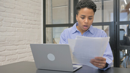 Young African Woman Feeling Upset while Reading Contract at Work