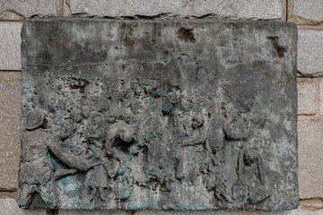 Holocaust memorial, Paris, France. Relief depicting the persecution of Jews sculpted by Arbit Blatas, in 1982 - obrazy, fototapety, plakaty