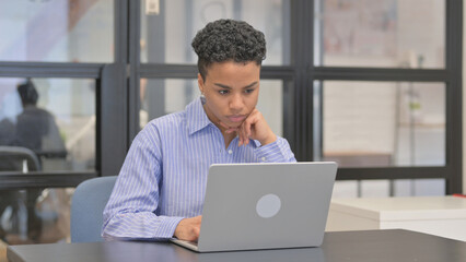 Mixed Race Woman Brainstorming while Using Laptop