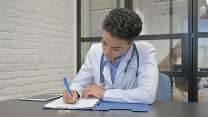 African Female Doctor Writing Medical Documents