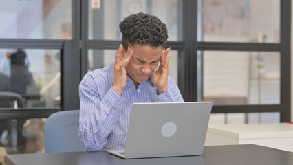 Mixed Race Woman having Headache while Using Laptop