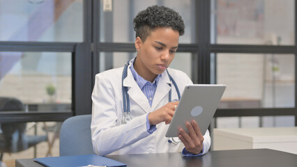 Mixed Race Female Doctor Working on Tablet