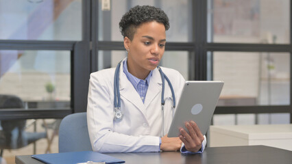 Online Video Chat on Tablet by Mixed Race Female Doctor