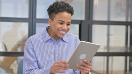 Portrait of African Woman Celebrating on Digital Tablet