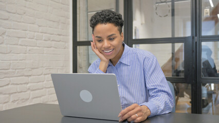 Young African Woman Doing Video Chat via Laptop