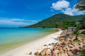 Beautiful tropical sand beach with rock and blue sea water at morning on Koh Phangan island, Thailand - 777404997