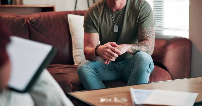Psychology, man and hands with discussion in counseling for trauma, anxiety and ptsd on sofa. Veteran, therapy session and nervous with mental health on couch for rehabilitation, stress or depression