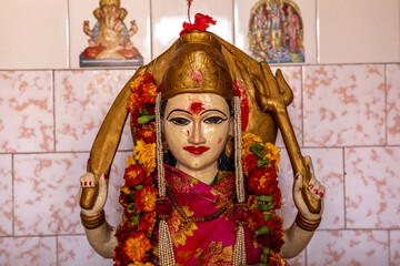 Hindu temple in Babra village, Maharashtra, India. Murthi (statue) of goddess Durga holding a...