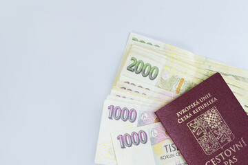 Various denominations of CZK koruna banknotes are stacked on white background in Czech Republic passport