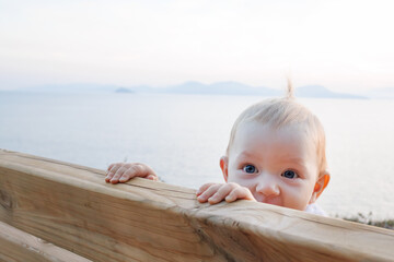 Little Toddler Female With Blue Eyes And Blond Hair Alone; On A Bench. Toddler Parenting. Growing...