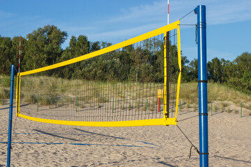 Volleyball yellow net on sand at beach. Sport and healthy lifestyles on fresh air
