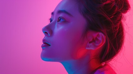 A woman's profile against a vibrant pink and blue background