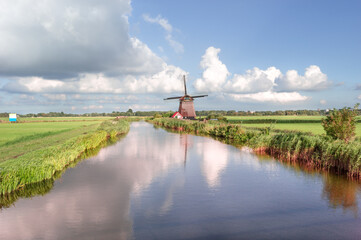 Windmill on the river in Holland