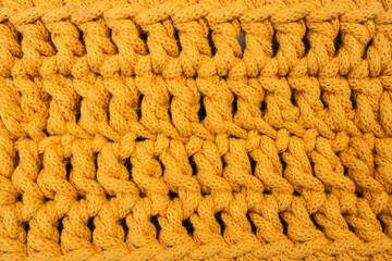 Orange cotton cord crochet pattern, abstract texture background, soft focus close up
