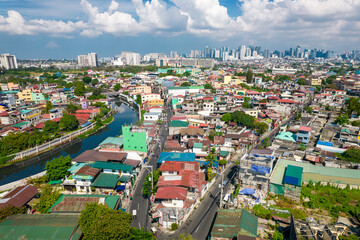 Fototapeta na wymiar Taguig, Metro Manila, Philippines - Aerial of the Taguig River and the cityscape, with the BGC skyline in the horizon.